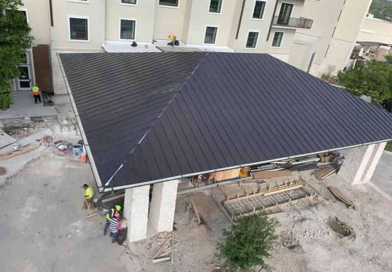 Metal roofing installation team working on a commercial building in Norridge
